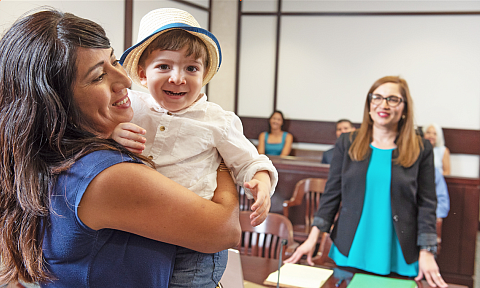 Mother with her son in a courtroom.