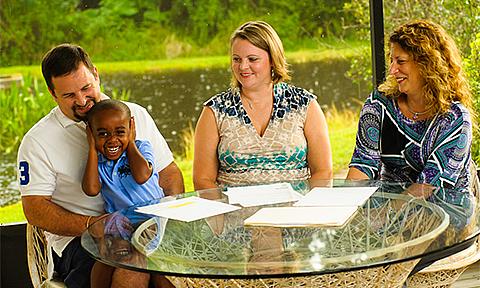 Foster family and attorney laughing