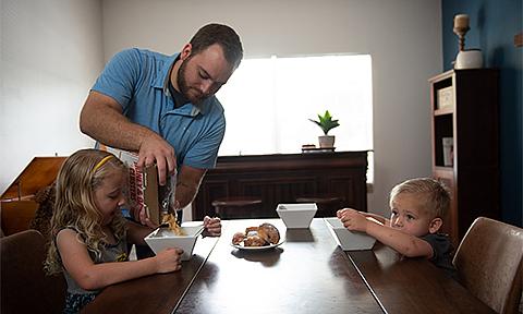 Father and children having breakfast